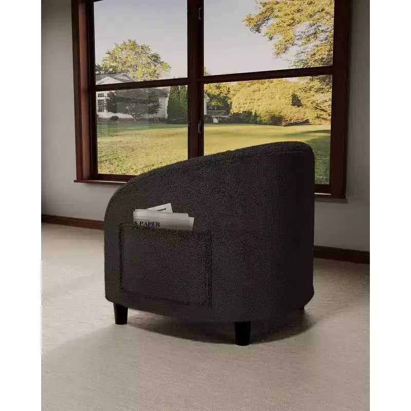 Poltrona a barilotto in tessuto bouclé nei colori nero/grigio scuro/bianco/giallo, con seduta singola