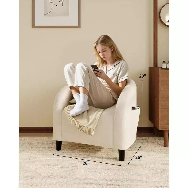 Poltrona a barilotto in tessuto bouclé nei colori nero/grigio scuro/bianco/giallo, con seduta singola