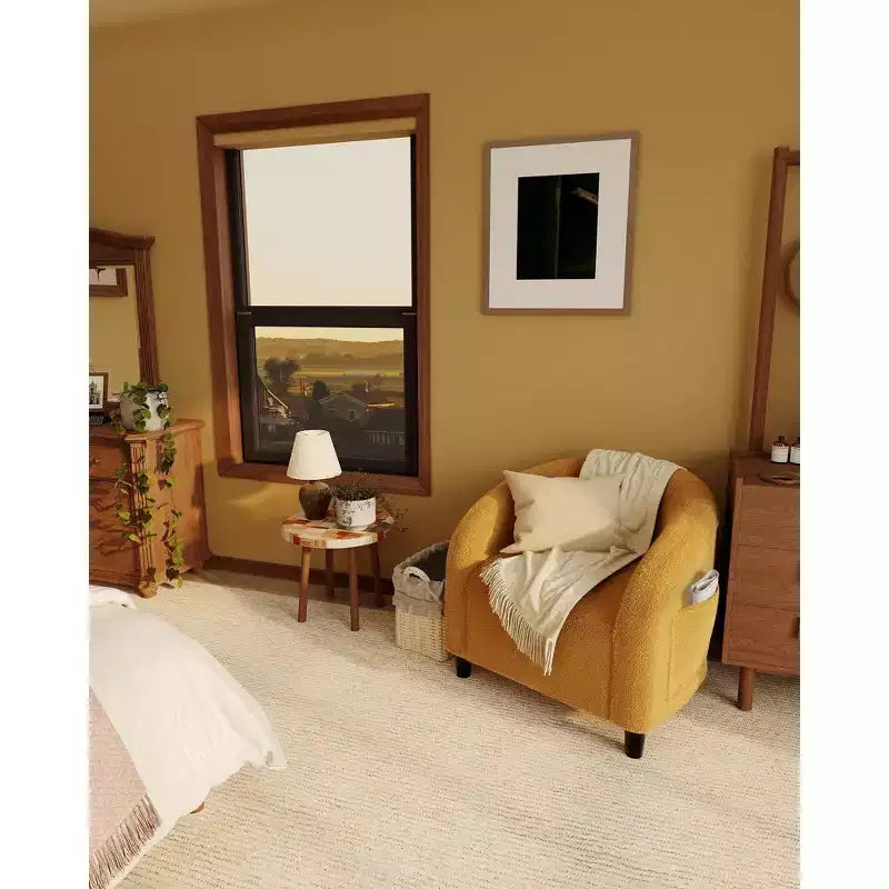 Poltrona a barilotto in tessuto bouclé nei colori nero/grigio scuro/bianco/giallo, con seduta singola
